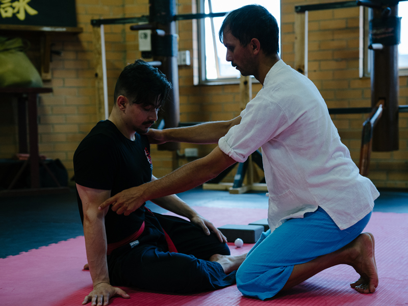 Giovanni Instructing someone in a Thai Yoga Class