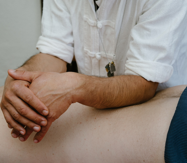 A massage therapist doing a massage on the back of a patient