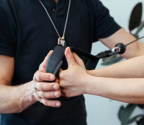 a therapist guiding the hands patient during an exercise