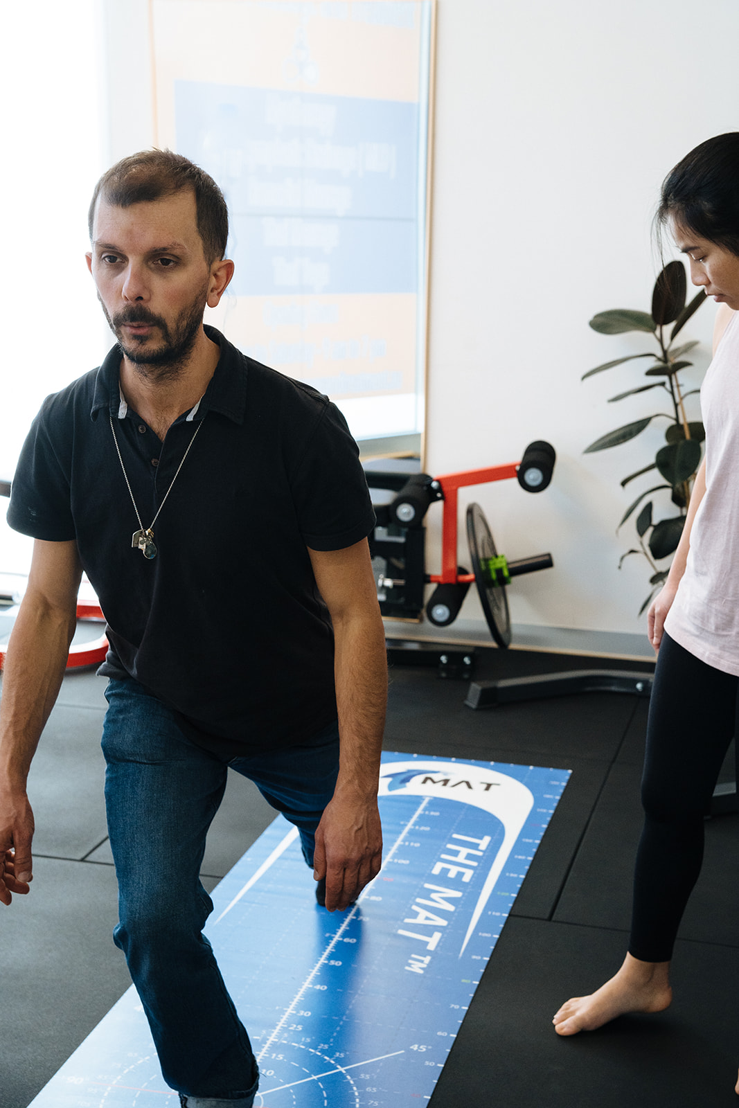 Giovanni doing a mobility/stability test on The Mat for ACL Rehab during a 1:1 Fitness Class