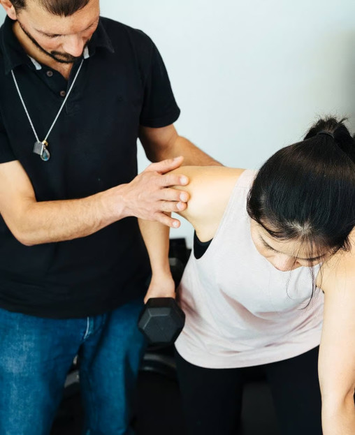 Giovanni of Melbourne Massage and Treatment, helping a patient.