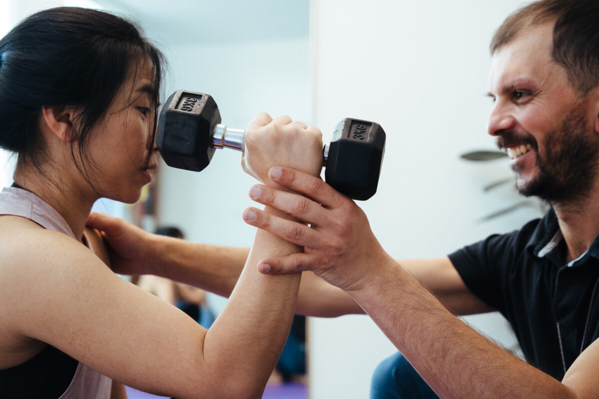 Giovanni showing exercises to his client along a Myotherapy session in Coburg